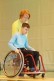 Foto: Ein Schüler fährt im Rollstuhl über eine Rampe mit einem Helfer, der ihn sichert.